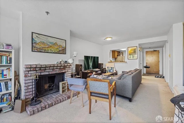 a view of a livingroom with furniture window and a fireplace