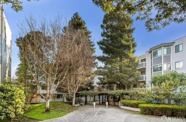 a view of a building with potted plants and palm trees