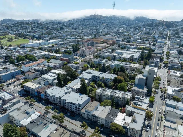 an aerial view of residential houses with outdoor space