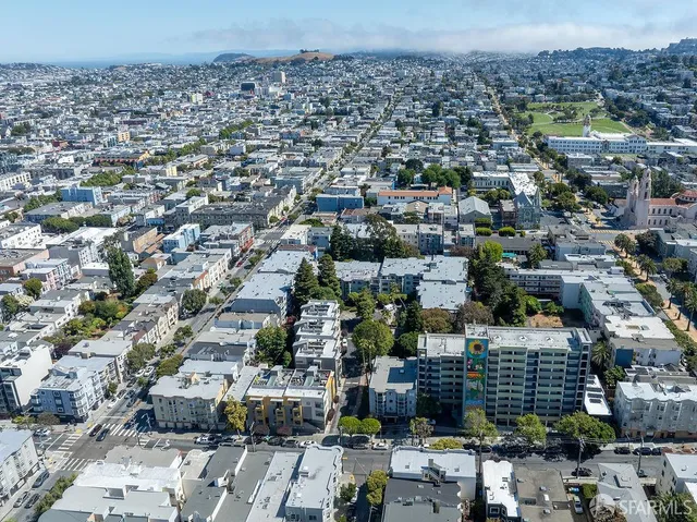 a view of a swimming pool with a lawn chairs under an umbrella