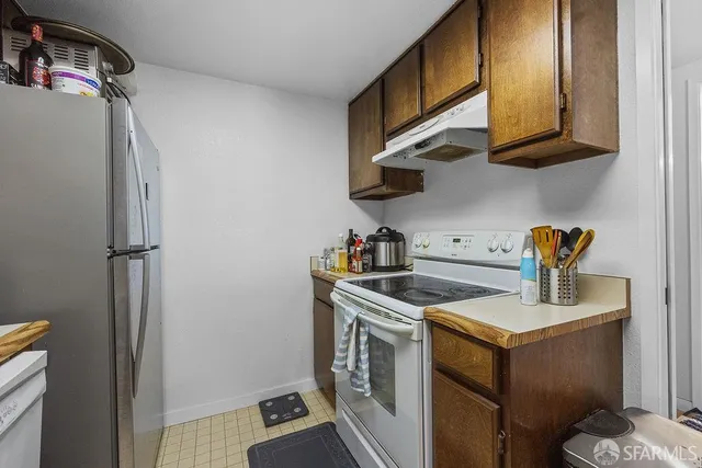 a kitchen with a sink cabinets and a window