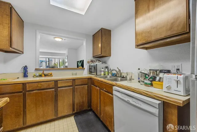 a open kitchen with sink refrigerator and cabinets