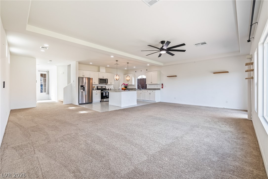 5510 Ripple Ridge Avenue Las Vegas, NV 89139 - Photo 19 of 45 This expansive open concept space offers a versatile layout, seamlessly connecting living areas with a modern kitchen.