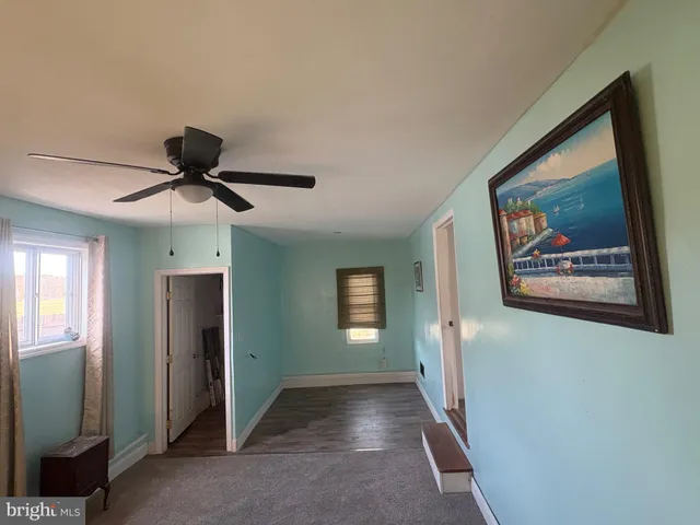 a view of hallway with window and stairs