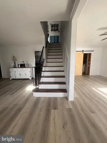 a view of entryway and hall with wooden floor