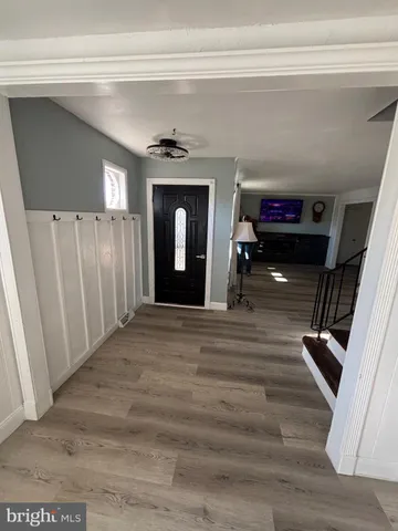 a view of a livingroom with furniture and staircase