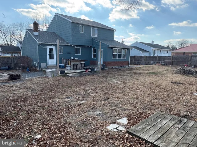 a view of a house with a yard and sitting area