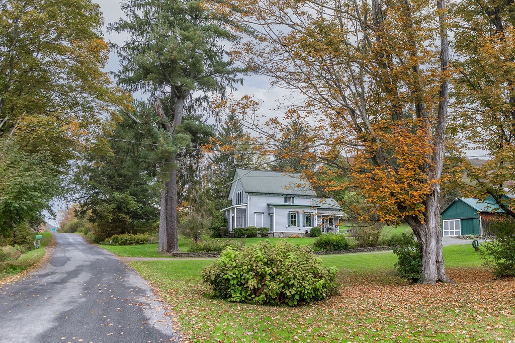 67 Fisk Road Bovina, NY 13753 - Photo 43 of 48 Mature trees frame a classic country home set back on a quiet road.