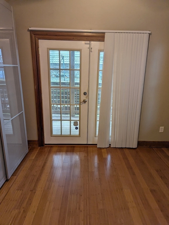 176 Hillside Street, Unit 101 Boston, MA 02120 - Photo 12 of 20 a view of an empty room with wooden floor and a window