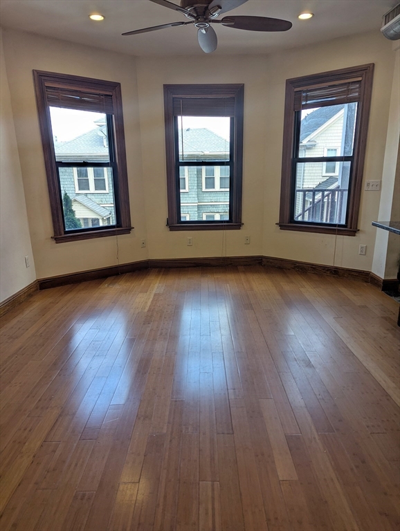 176 Hillside Street, Unit 101 Boston, MA 02120 - Photo 7 of 20 a view of an empty room with wooden floor and a window