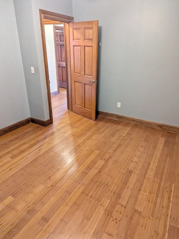 176 Hillside Street, Unit 101 Boston, MA 02120 - Photo 9 of 20 a view of an empty room and wooden floor