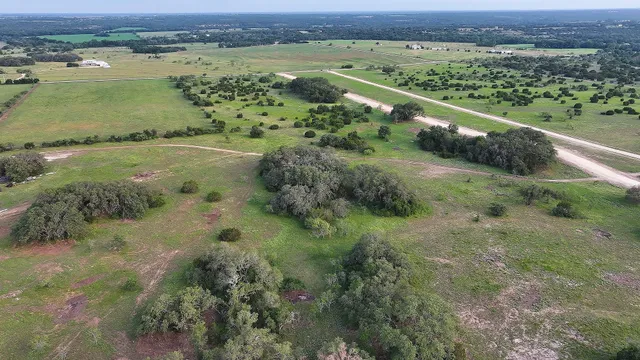 an aerial view of a residential houses with outdoor space