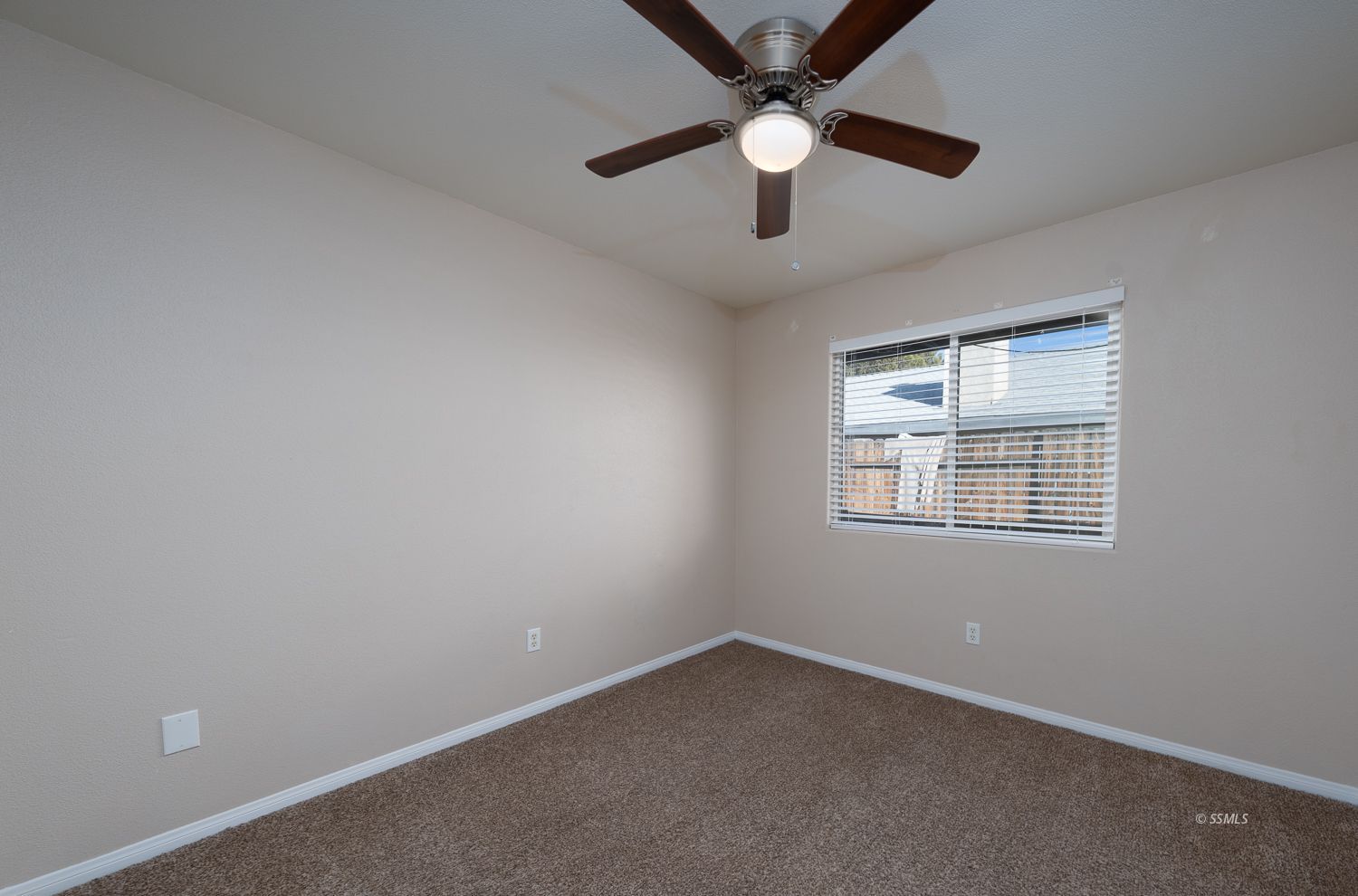 1237 West Boston Avenue Ridgecrest, CA 93555 - Photo 19 of 32 an empty room with a window and a fan