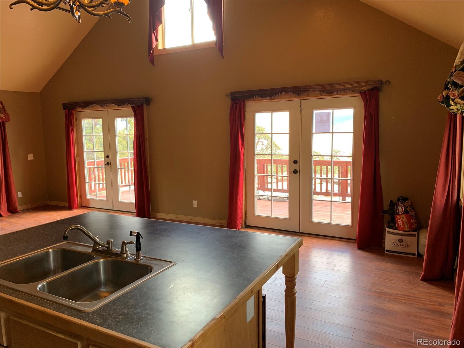 1720 Thunder Road Lake George, CO 80827 - Photo 11 of 40 a kitchen with a sink and a large mirror next to a window