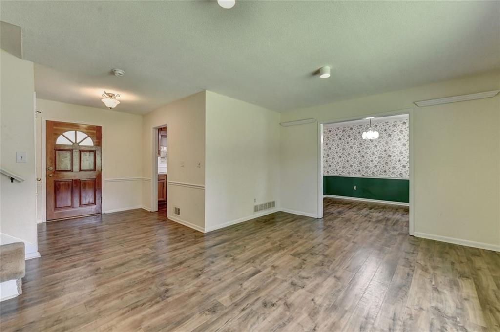 1577 Harbour Oaks Road Tucker, GA 30084 - Photo 8 of 58 a view of an empty room with window and wooden floor