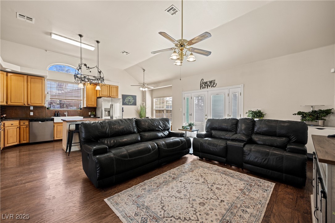 1951 Jim Haworth Court Logandale, NV 89021 - Photo 13 of 63 Living area featuring dark wood-style flooring, visible vents, vaulted ceiling, and ceiling fan