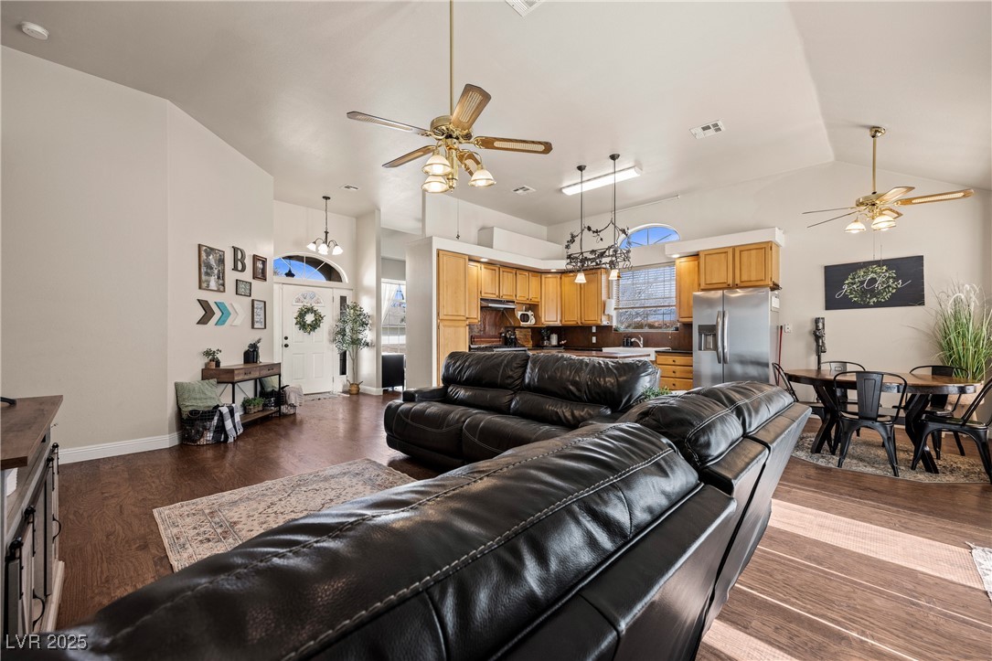 1951 Jim Haworth Court Logandale, NV 89021 - Photo 16 of 63 Living room with a wealth of natural light, ceiling fan with notable chandelier, visible vents, and wood finished floors
