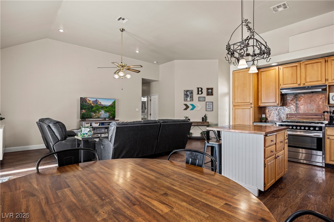 1951 Jim Haworth Court Logandale, NV 89021 - Photo 62 of 63 Kitchen featuring visible vents, dark wood finished floors, open floor plan, high end stainless steel range oven, and under cabinet range hood