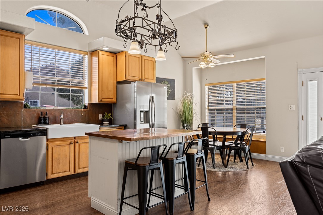 1951 Jim Haworth Court Logandale, NV 89021 - Photo 20 of 63 Kitchen featuring stainless steel appliances, a kitchen bar, dark wood finished floors, and decorative backsplash