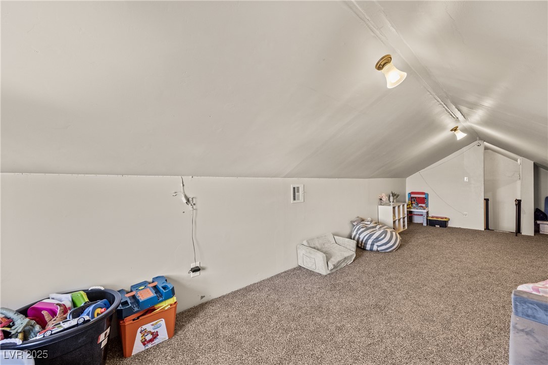 1951 Jim Haworth Court Logandale, NV 89021 - Photo 32 of 63 Rec room featuring lofted ceiling, visible vents, carpet flooring, and rail lighting