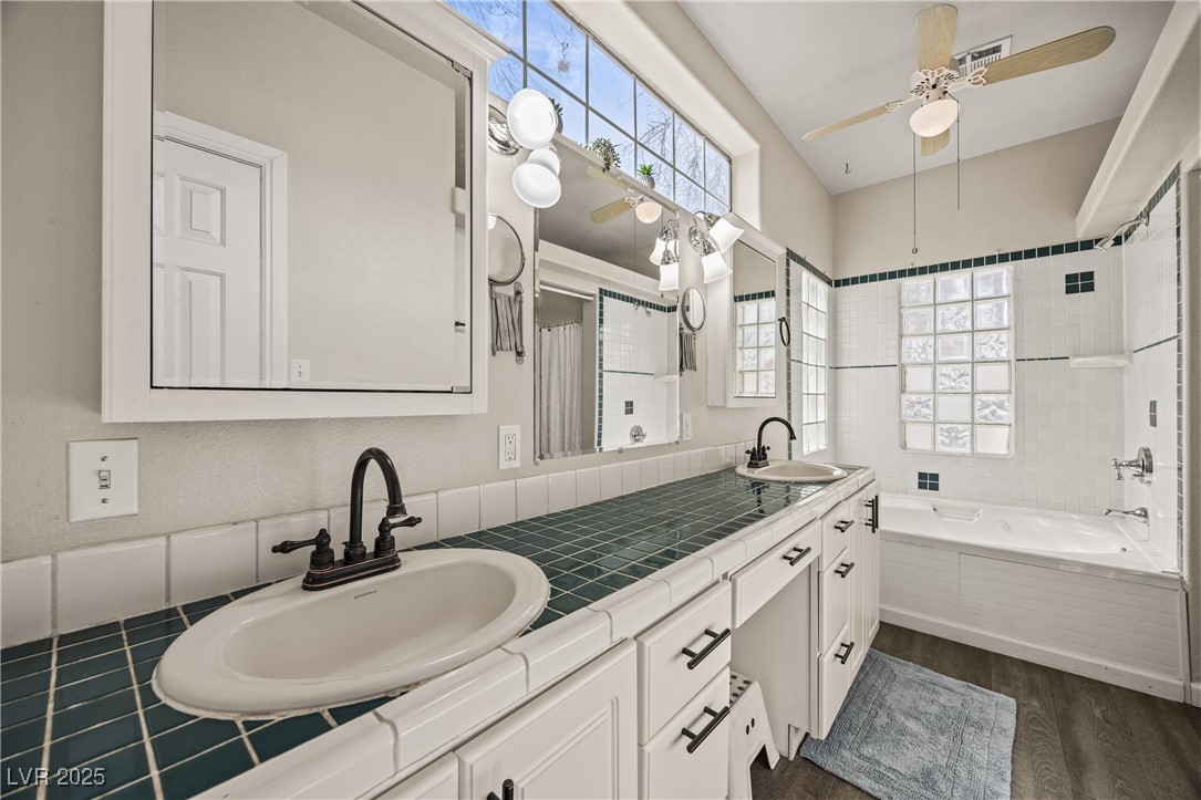 1951 Jim Haworth Court Logandale, NV 89021 - Photo 37 of 63 Bathroom featuring a healthy amount of sunlight, a sink, and wood finished floors