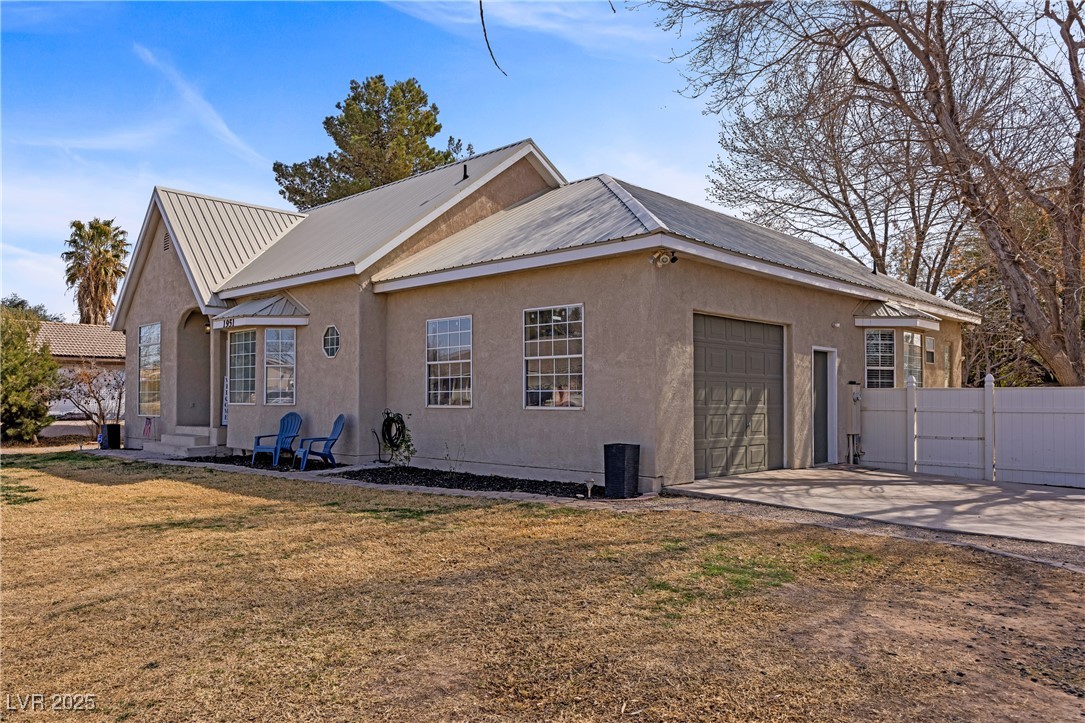 1951 Jim Haworth Court Logandale, NV 89021 - Photo 4 of 63 2 car garage, concrete driveway, metal roof, and an attached garage