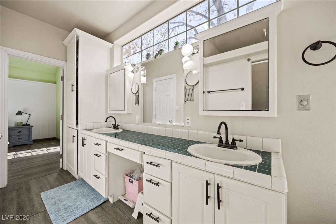1951 Jim Haworth Court Logandale, NV 89021 - Photo 39 of 63 Bathroom featuring double vanity, a sink, and wood finished floors