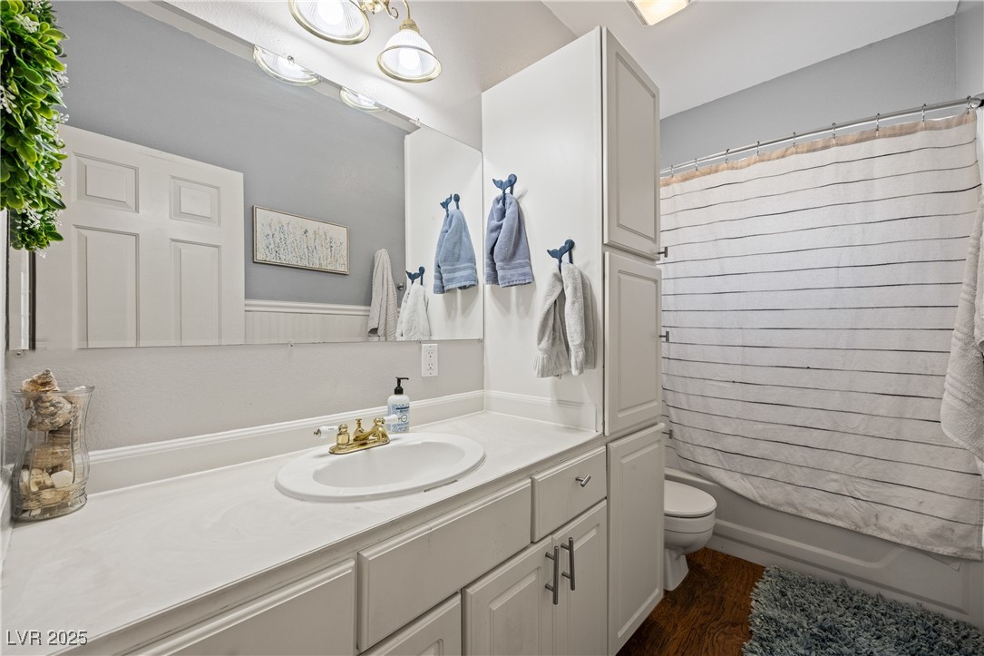 1951 Jim Haworth Court Logandale, NV 89021 - Photo 44 of 63 Full bath with toilet, shower / bath combination with curtain, wood finished floors, and vanity