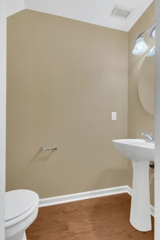 a bathroom with a sink a toilet and mirror
