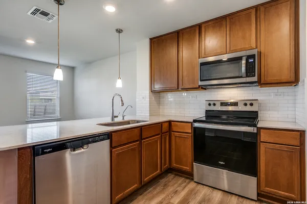 a kitchen with a sink stove and microwave