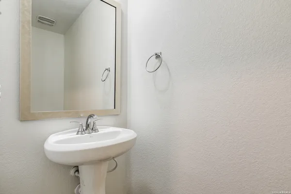 a bathroom with a sink and mirror