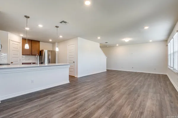 a view of kitchen with sink and wooden floor