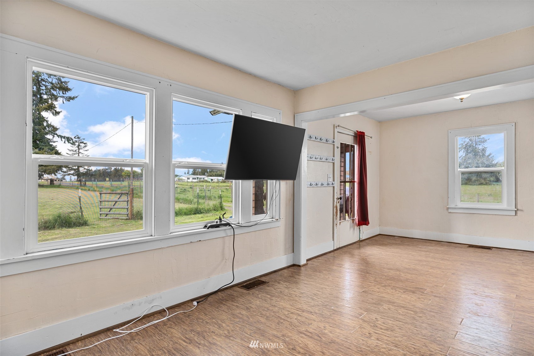 104 Reinseth Road Winlock, WA 98596 - Photo 4 of 35 a view of an empty room with a window and wooden floor