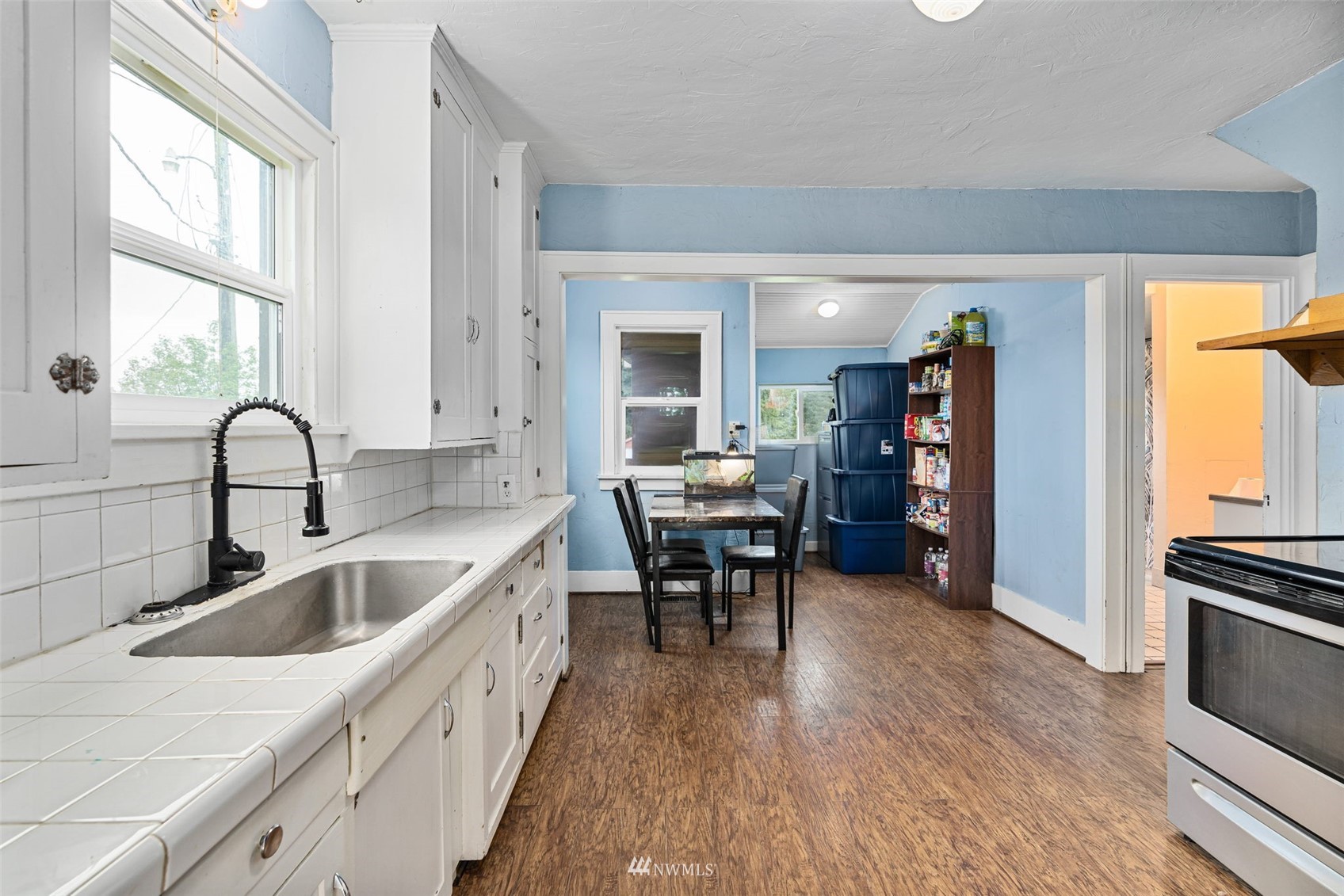 104 Reinseth Road Winlock, WA 98596 - Photo 7 of 35 a kitchen with sink cabinets and wooden floor
