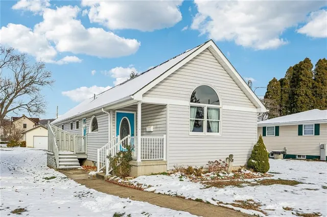 a view of a house with snow on the road