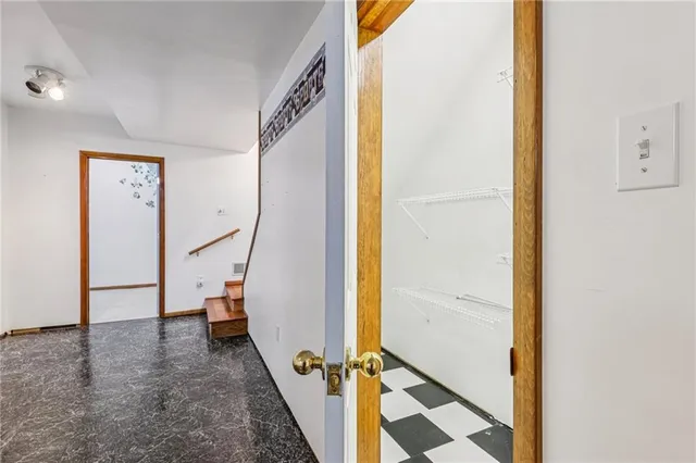 a view of an empty room and a bathroom