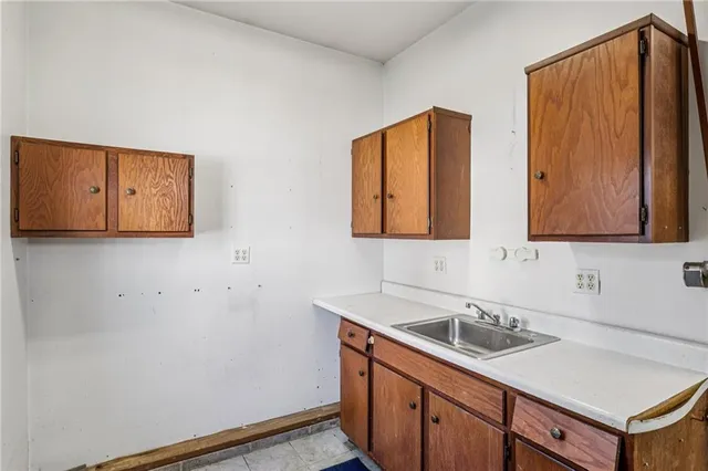 a view of a house with a yard and large trees