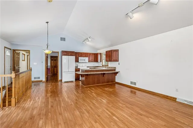 a living room with furniture and kitchen view