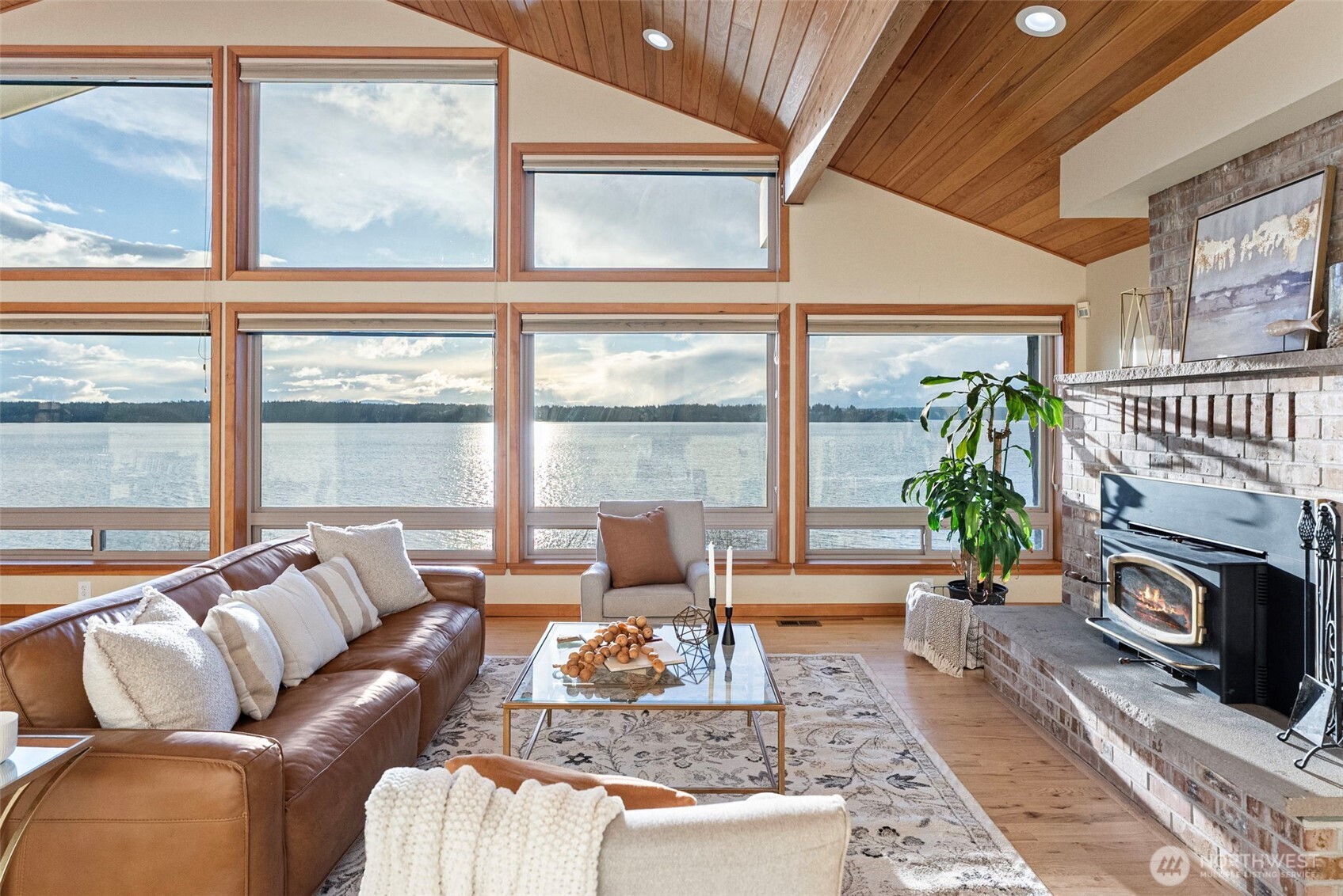 17510 88th Street Southwest Longbranch, WA 98351 - Photo 4 of 40 a living room with furniture a fireplace and a floor to ceiling window