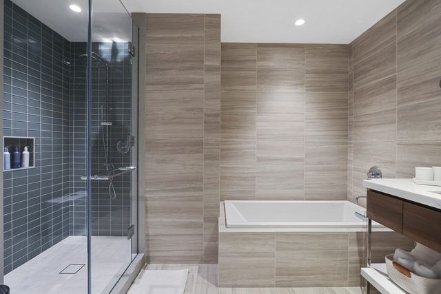 a bathroom with a bathtub and shower