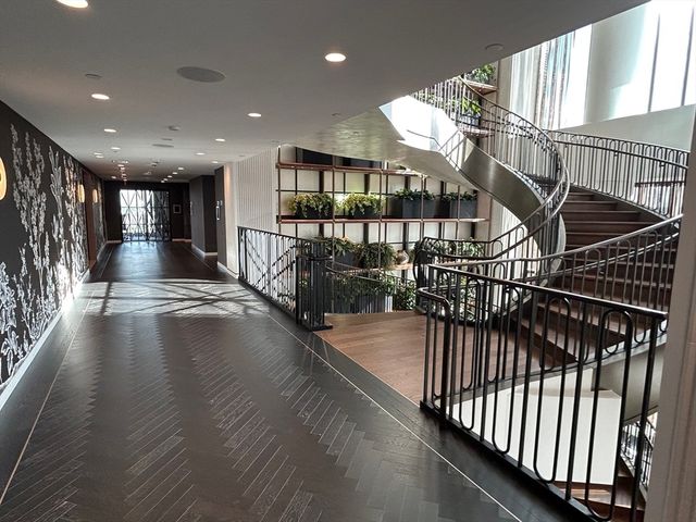 a living room with lots of white furniture and a chandelier