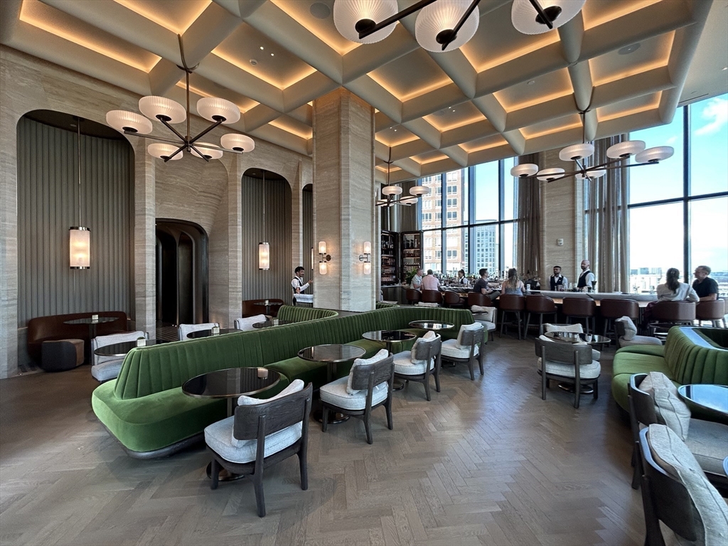 40 Trinity Place, Unit 1612 Boston, MA 02116 - Photo 30 of 38 a living room with lots of white furniture and a chandelier