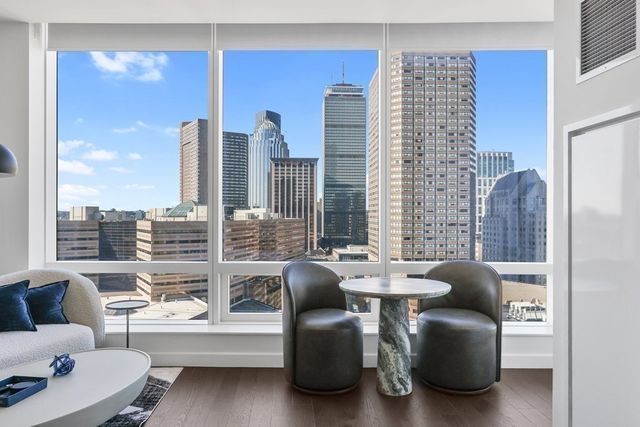 a balcony with furniture and a large window