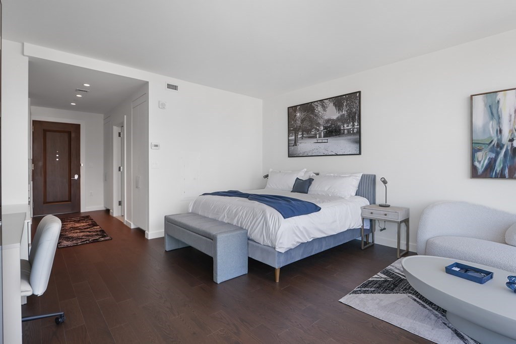 40 Trinity Place, Unit 1612 Boston, MA 02116 - Photo 9 of 38 a spacious bedroom with a bed a couch and a window