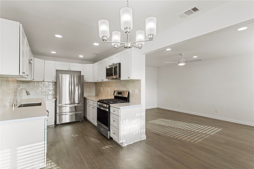 9219 Colorado Avenue Riverside, CA 92503 - Photo 14 of 30 a kitchen with stainless steel appliances granite countertop a refrigerator a stove a sink and a center island