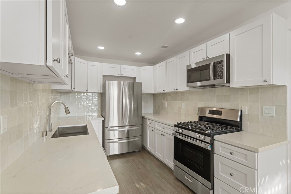 9219 Colorado Avenue Riverside, CA 92503 - Photo 15 of 30 a kitchen with stainless steel appliances granite countertop a refrigerator stove a sink and a microwave