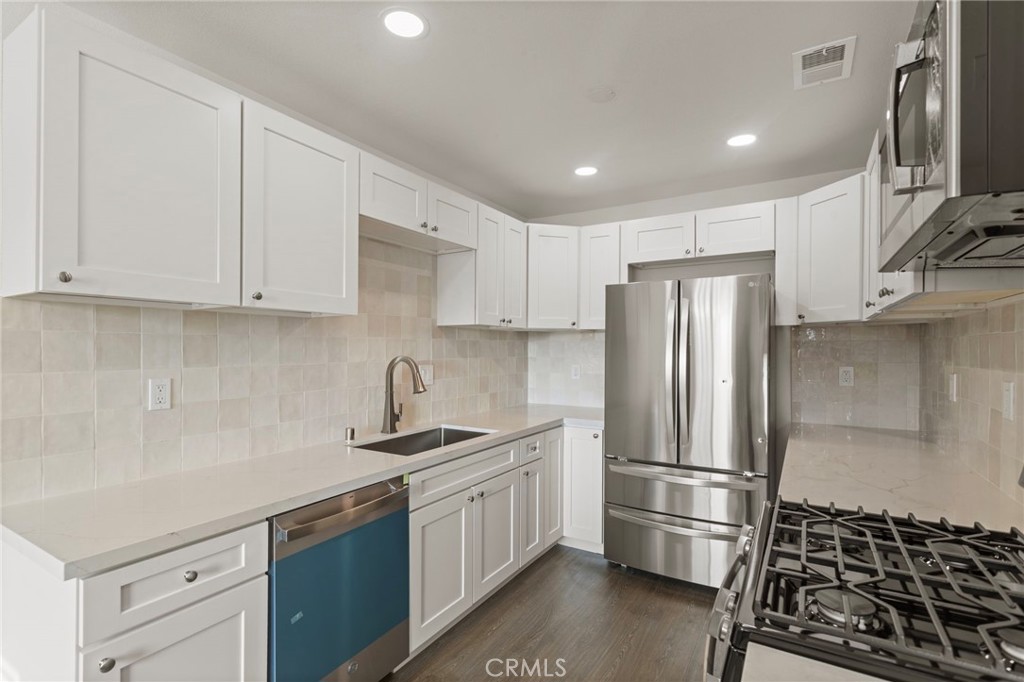 9219 Colorado Avenue Riverside, CA 92503 - Photo 16 of 30 a kitchen with a refrigerator sink and cabinets