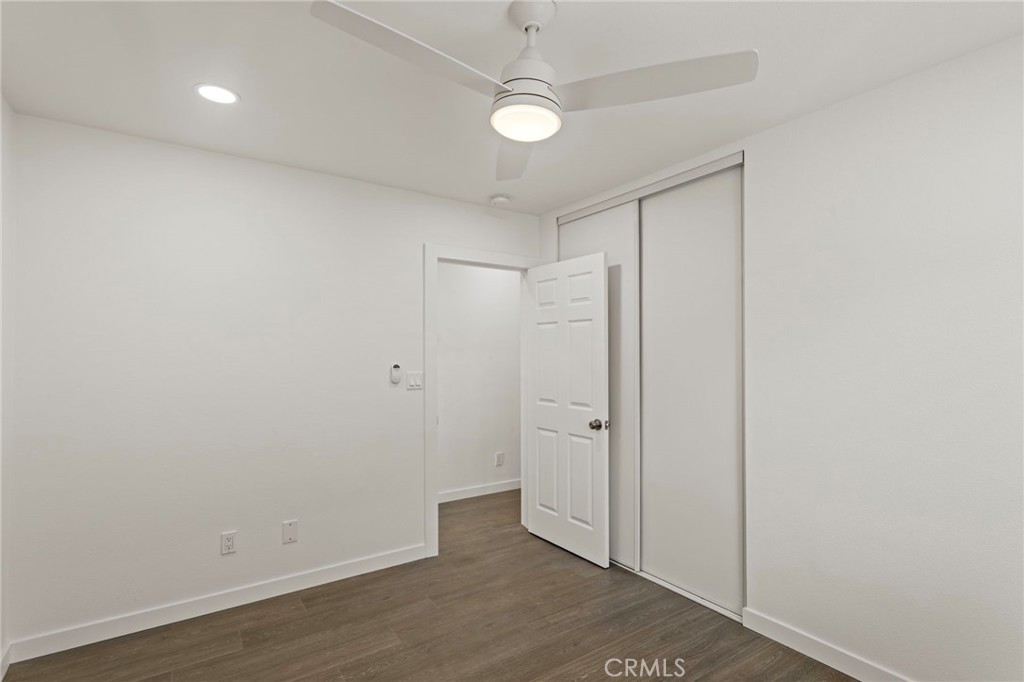 9219 Colorado Avenue Riverside, CA 92503 - Photo 19 of 30 an empty room with wooden floor and a ceiling fan