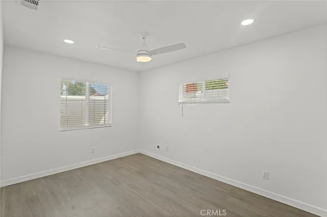 an empty room with a wooden floor and a window