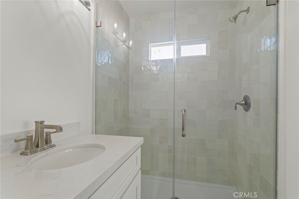 9219 Colorado Avenue Riverside, CA 92503 - Photo 28 of 30 a bathroom with a sink a shower and a mirror